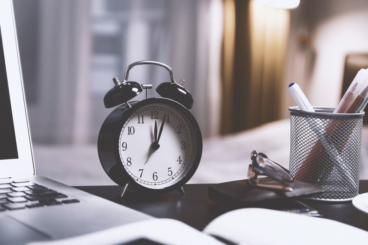 Clock ticks at desk where student procrastinates