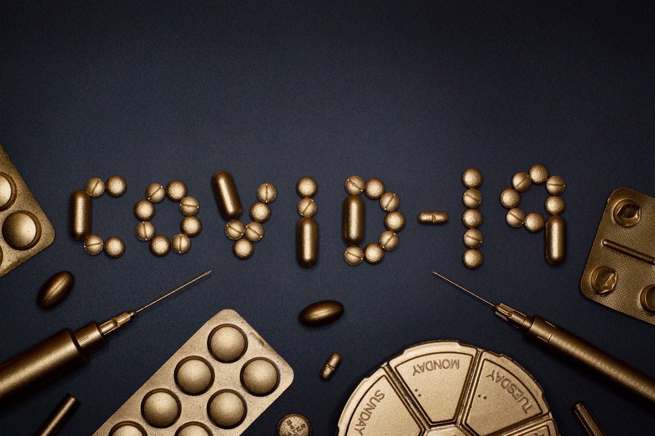 covid 19 written in gold pills