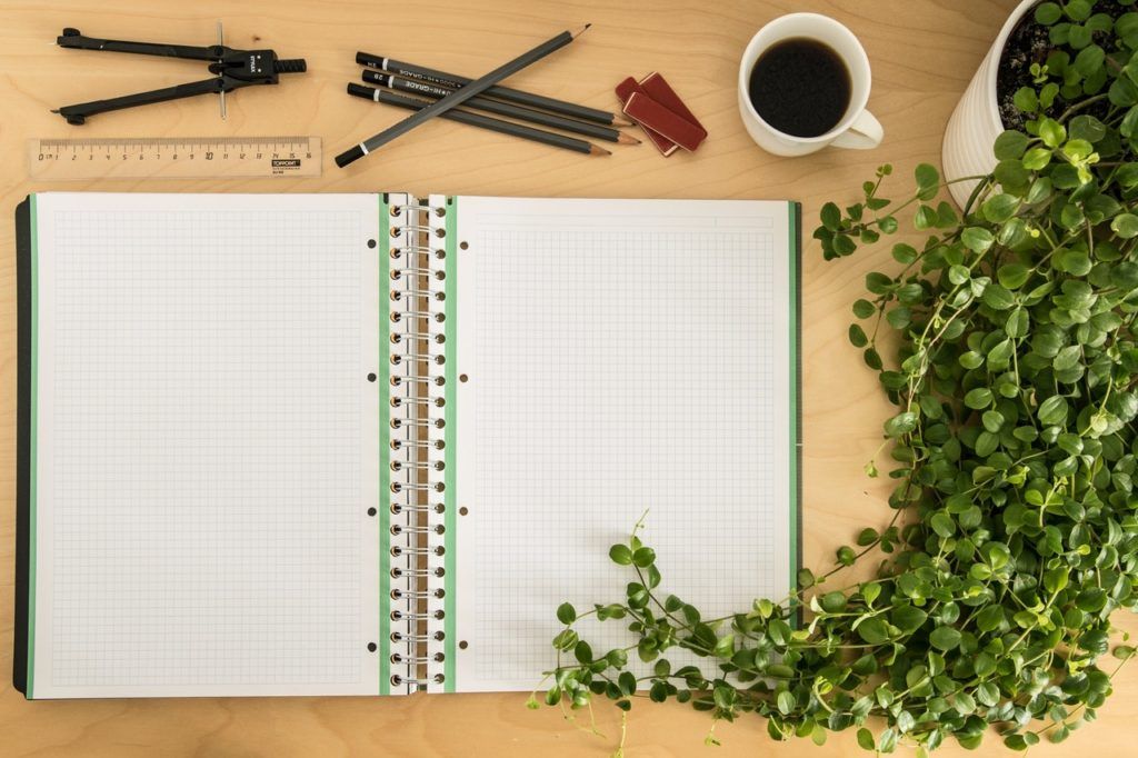 graph pad and writing utensils on desk