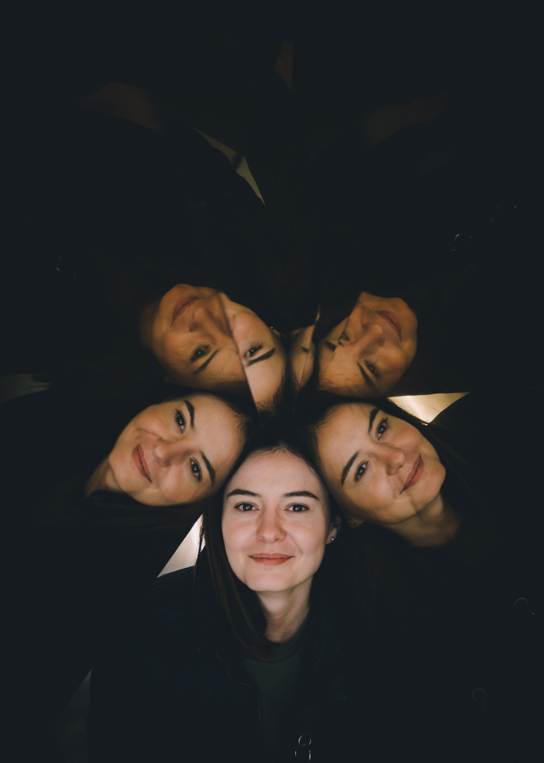 dark background 5 faces in center