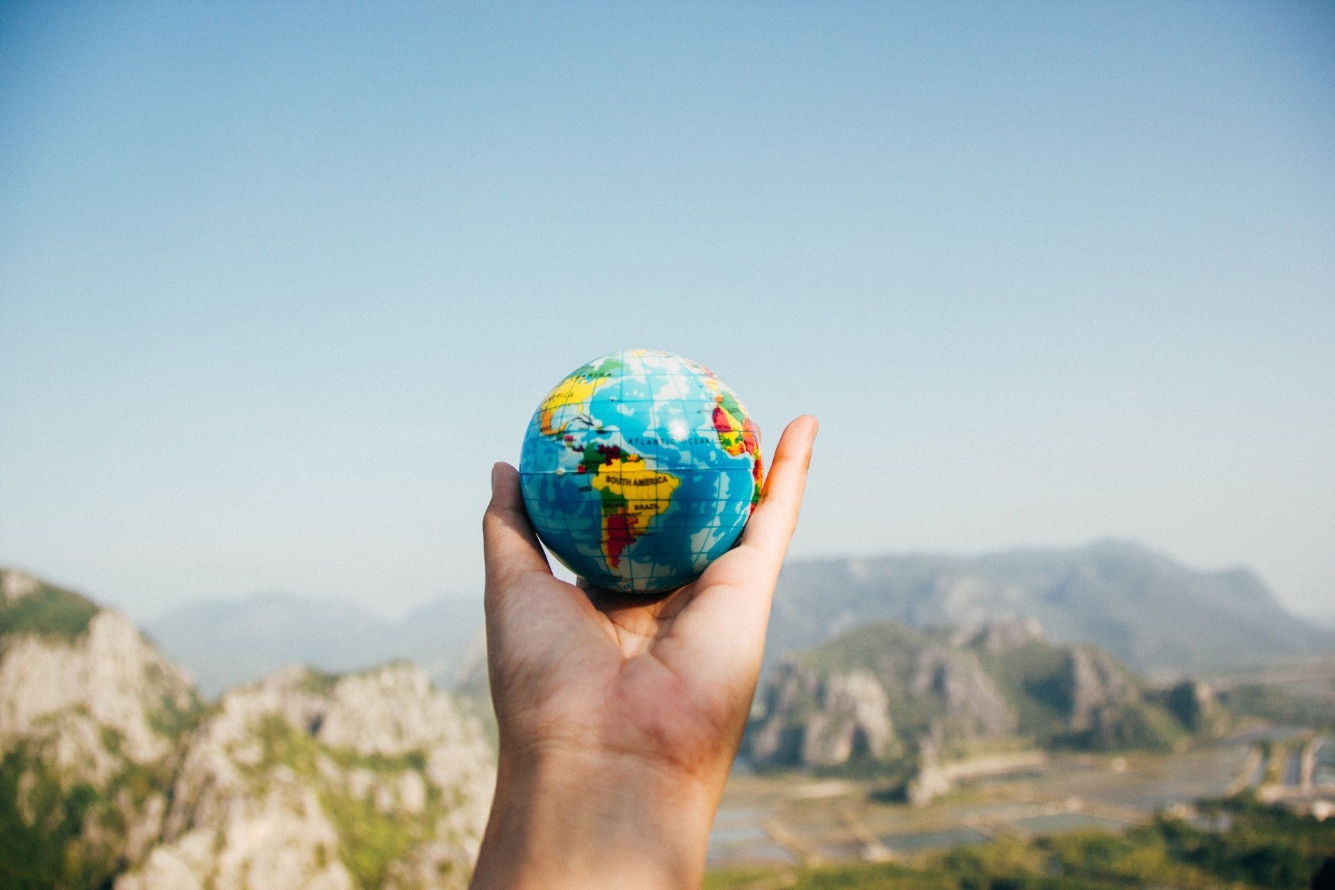 Person holding a globe.