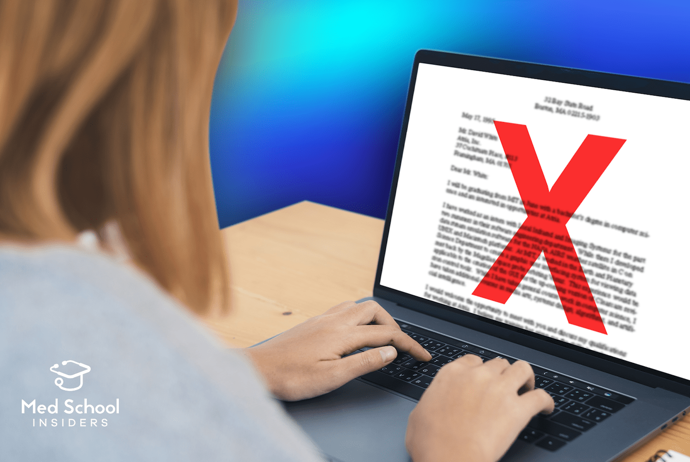Female student typing on laptop with giant X over the screen