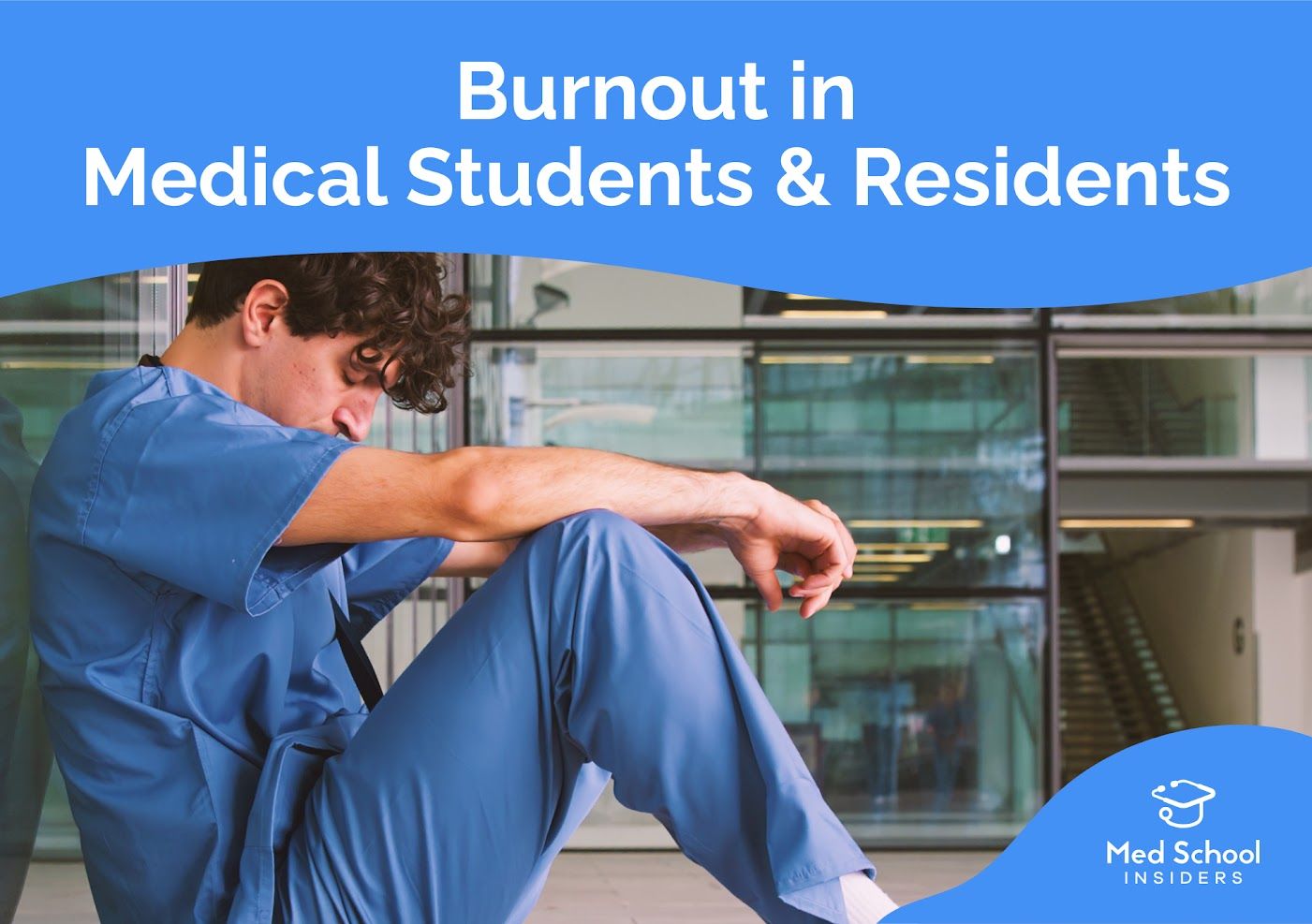 Medical student in scrubs sitting on the floor with head down, illustrating burnout and mental health challenges among medical students and residents.