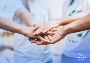 Close up of people volunteer teamwork putting hands together