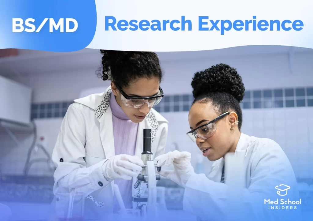 BS/MD. Research Experience. Two young women in a lab, looking through a microscope