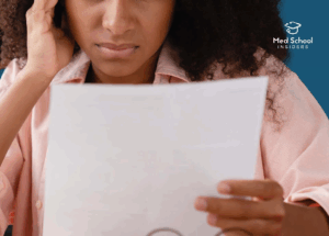 Student looking disappointed while reviewing a poorly written personal statement