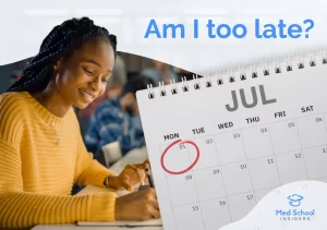 A premed student writing notes next to a July calendar with a circled deadline, representing the question of how late you can submit a primary medical school application.