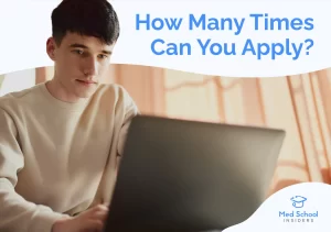 A focused premed student sitting with a laptop considering how many times to apply to medical school.