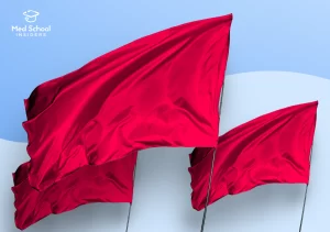 Three red flags waving against a blue background, symbolizing red flags in a medical school application.